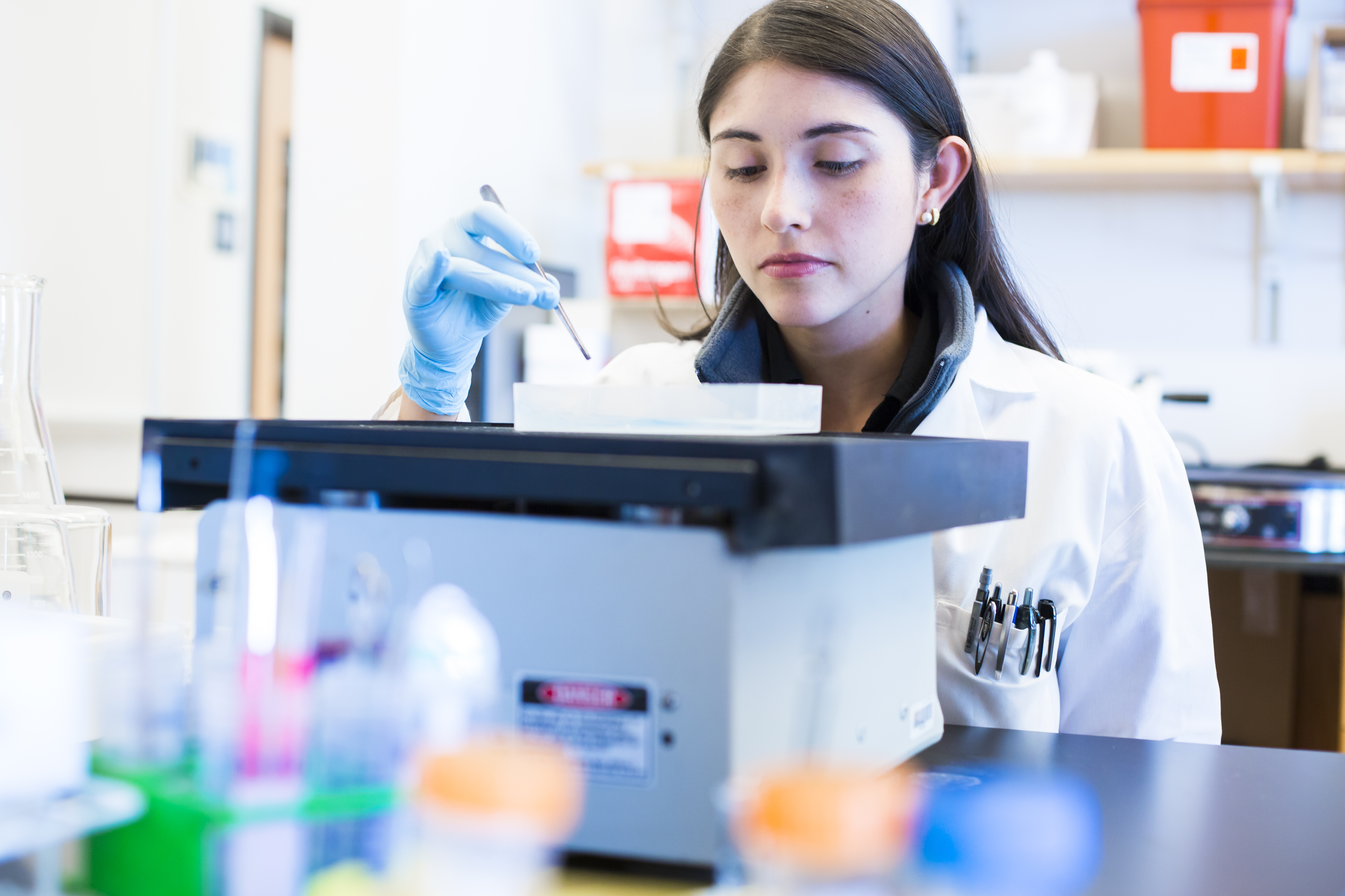 Researcher pipettes into machine